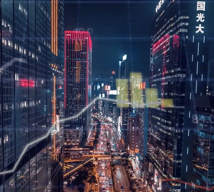 City skyline at night overlaid with market chart lines