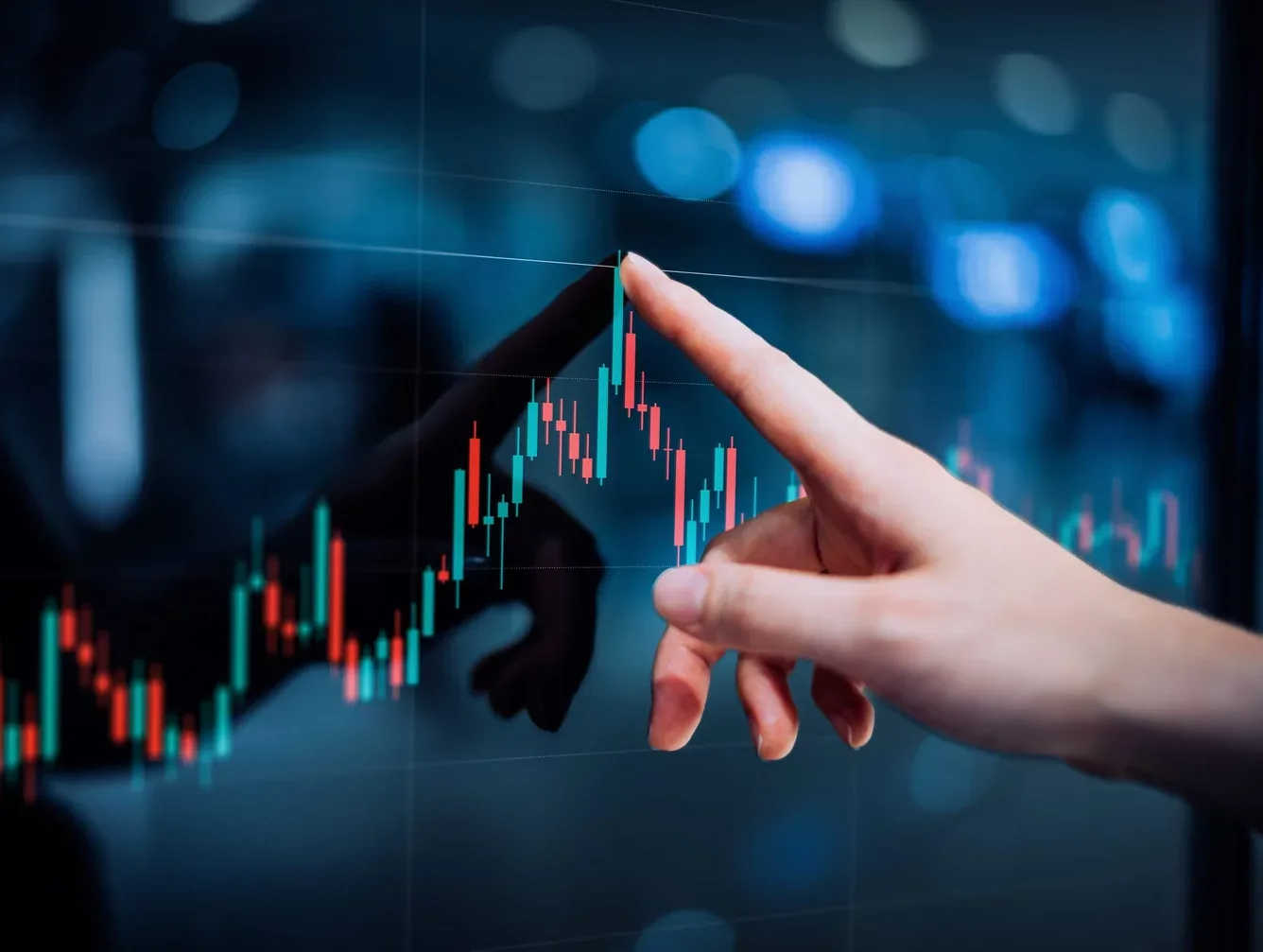 Trader reviewing a candlestick chart on a screen